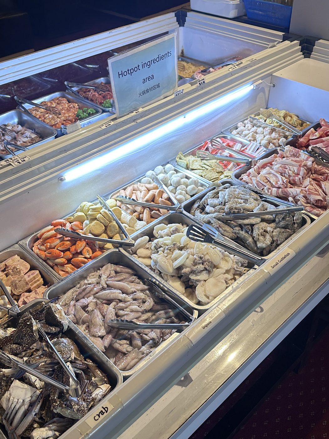 Chilled hotpot counter with crab, squid, small cuttlefish, prawns and rolled marbled pork belly