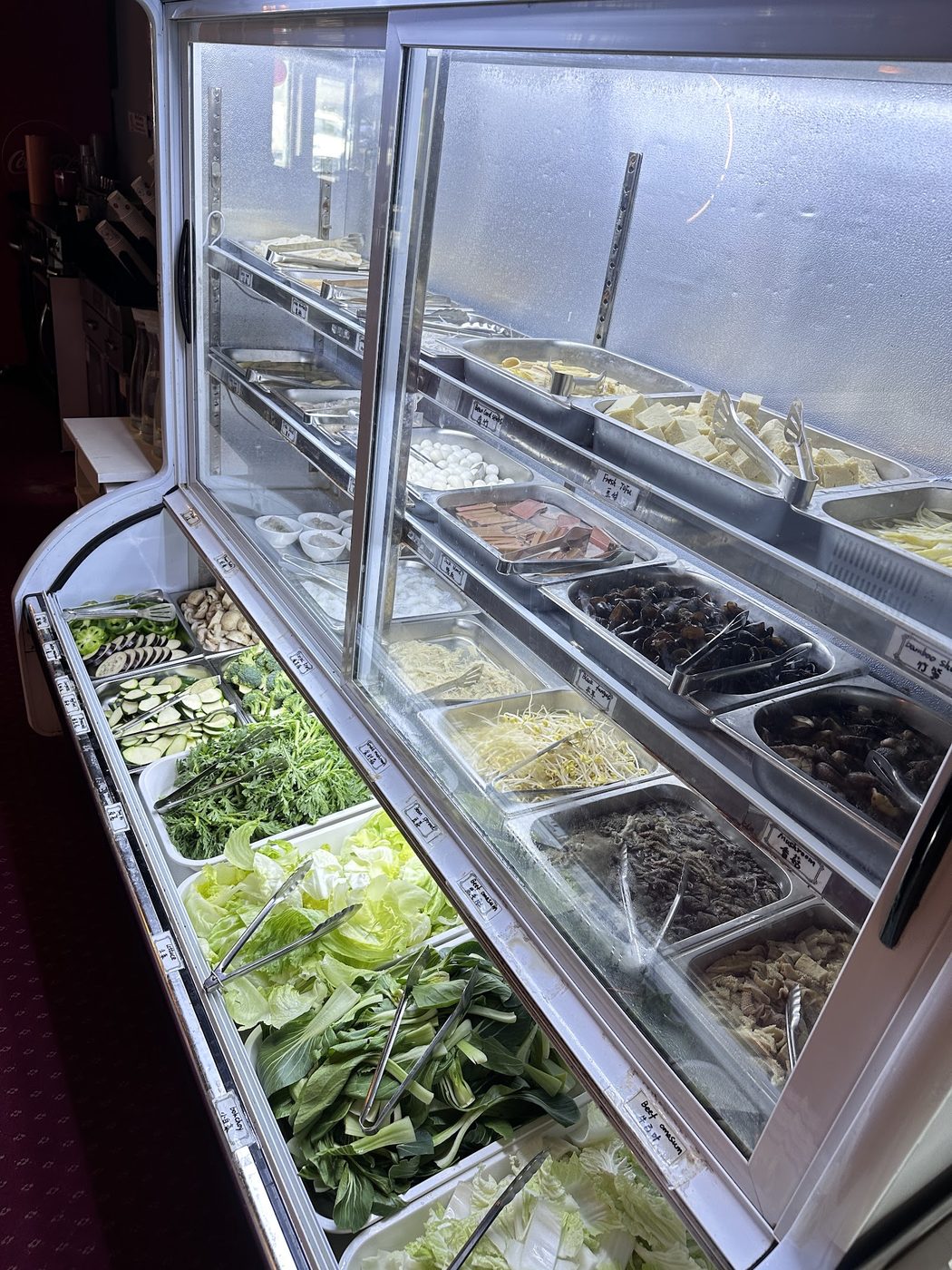 Chilled fridge of bok choy, lettuce, courgette, mushrooms and fresh tofu
